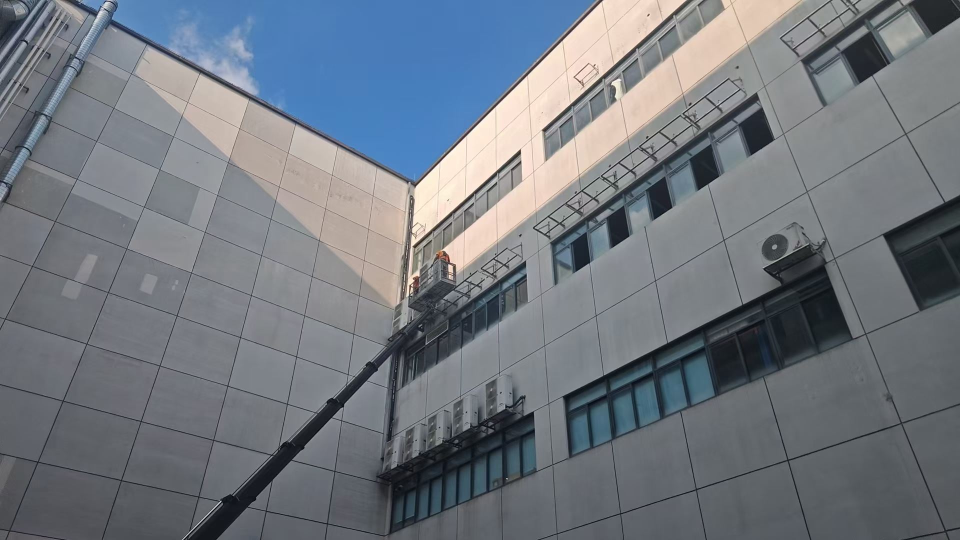扬程机电团队正在厂房高空安装空调外机